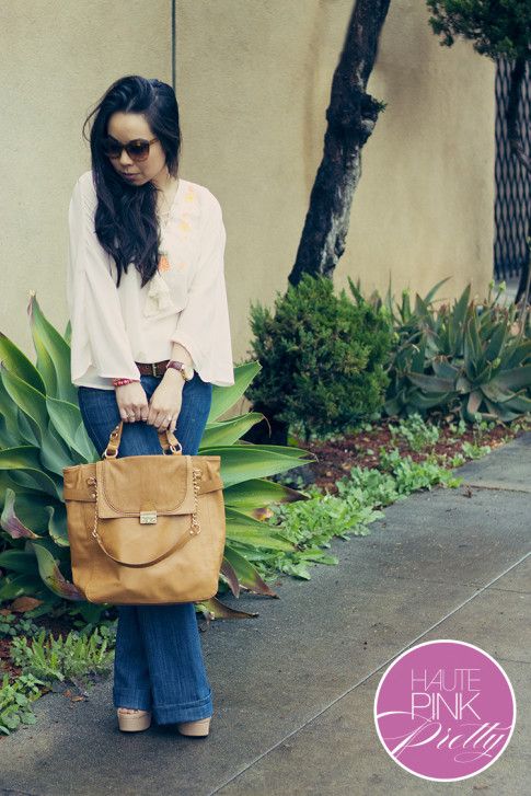 An Dyer wearing Sugarlips Apparel Ride the Caravan Top, Alice & Joy Camel Controversy Tote, Elizabeth & James Lafayette Sunglasses, Glint & Gleam Pink Gold Bracelets ShopLately, Frankie B Flared Jeans 2