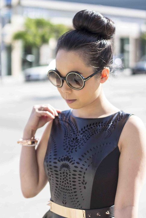 An Dyer wearing Lavishville LASER CUT FIT AND FLARE PONTE AND PLEATHER DRESS,  ASOS Black Plate And Spike Detail Waist Belt,Tom Ford Carrie Sunglasses